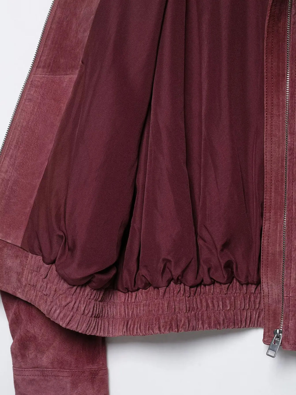 Interior lining and elasticated hem of marsala bomber jacket