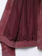 Interior lining and elasticated hem of marsala bomber jacket