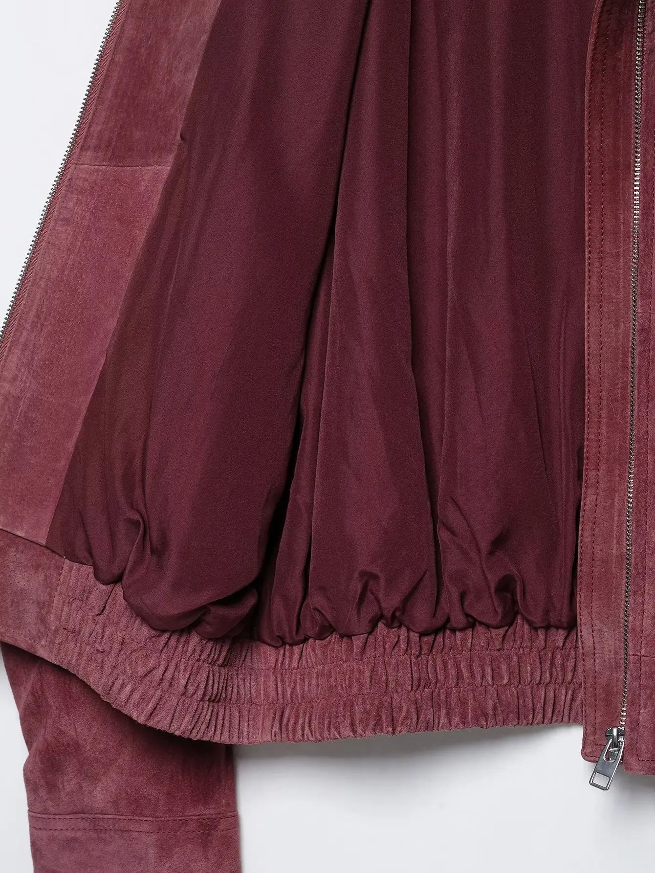 Interior lining and elasticated hem of marsala bomber jacket