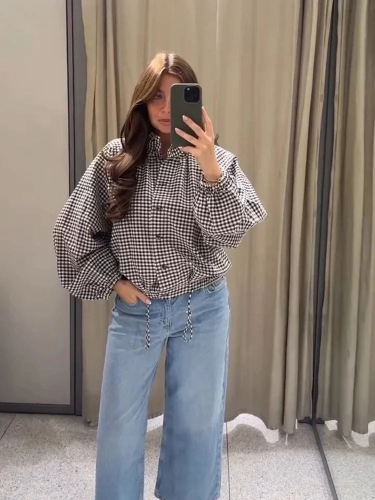 Black gingham check funnel-neck jacket worn with denim