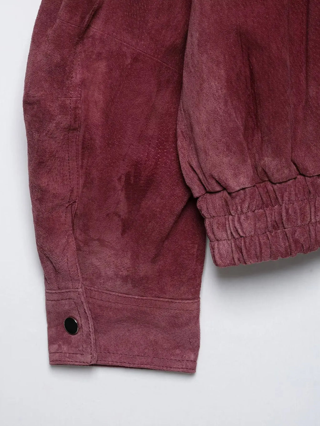 Snap-cuff sleeve detail on marsala faux suede bomber