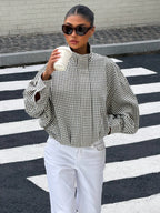 Black gingham funnel-neck jacket worn with white denim