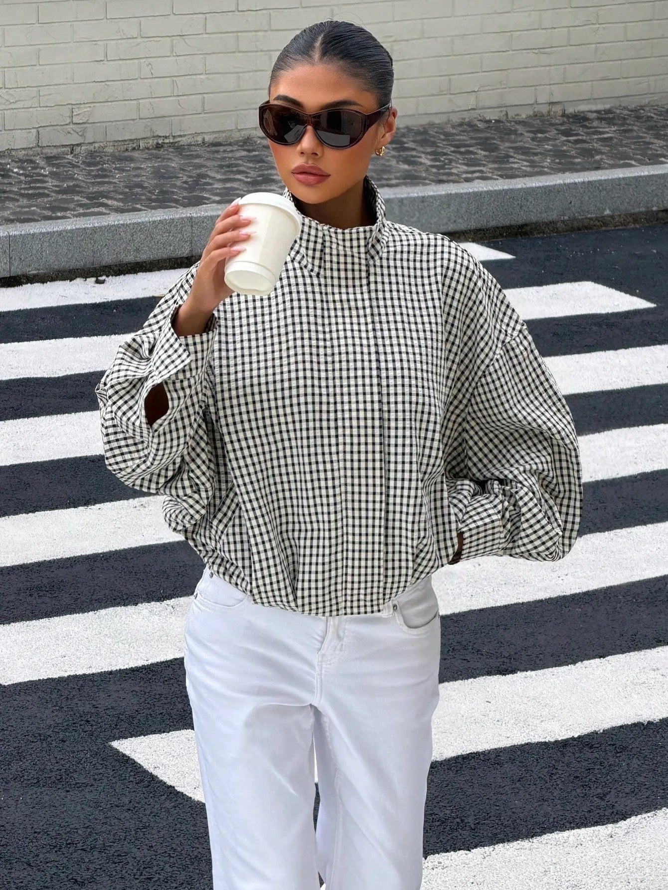 Black gingham funnel-neck jacket worn with white denim
