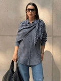 Navy plaid scarf-tie shirt worn with denim