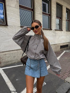 AW26 email — black gingham funnel-neck jacket with denim mini skirt