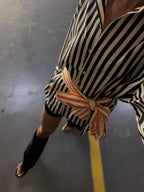 AW26 email — striped shirt belted with contrast orange tie
